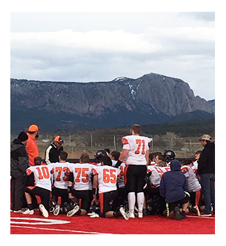 Capitan High School football players huddled up for a final meeting