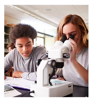 Two high school students using a microscope in class